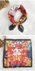 Detailed flat lay of Chinese festive cotton linen scarf featuring Ox Year illustration