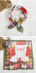 Detail of a Christmas cotton linen square scarf showing festive patterns and gift scenes