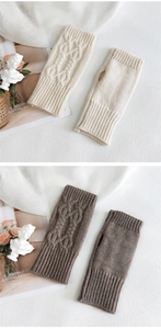 Macro shot of cable-knit fingerless gloves with thumb holes in cream and brown
