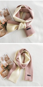 Detail of two-tone knit scarf with smile patch, pink and beige ribbed texture details