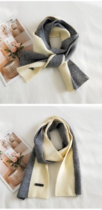 Detail of grey and beige bicolor knit scarf showing thick texture and brand label