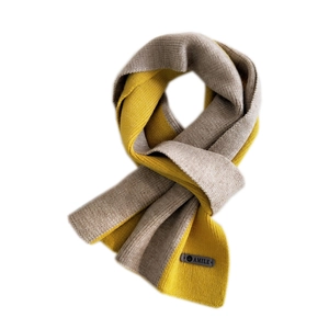 Two-tone yellow and grey knit scarf for women featuring a minimalist leather label