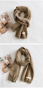 Close-up of khaki knitted scarf featuring fine texture and ribbed edge detailing
