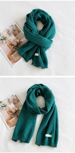 Macro view of solid emerald green knitted scarf texture and thick warm rib design
