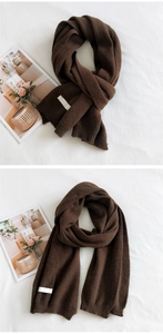 Detail of dark brown knitted scarf showing fine rib texture and cozy winter styling