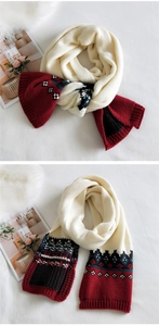 Detail of red and cream knitted scarf featuring geometric jacquard patterns and ribbed edges