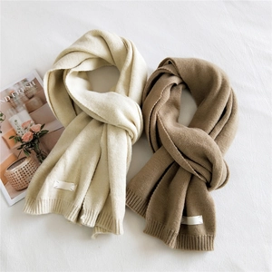 Solid color thick knit scarf in cream and brown with minimalist ribbed texture for winter