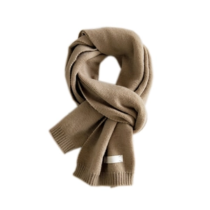 Thick solid camel knit scarf for women with warm ribbed texture and decorative label