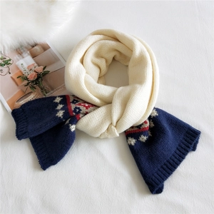 Thick knit winter scarf with Nordic geometric patterns in navy blue and cream white