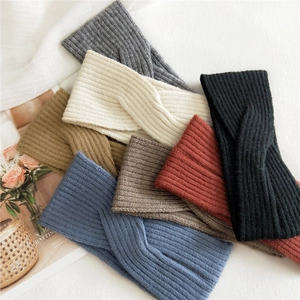 Knitted criss-cross headbands in various autumn colors with warm ribbed texture