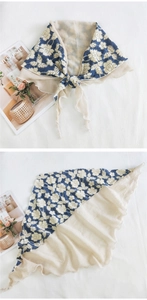 Detail view of double-layer triangle scarf with blue floral lace and cream fabric
