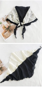 Detail of black chiffon and white floral lace patchwork shawl with delicate knotted style