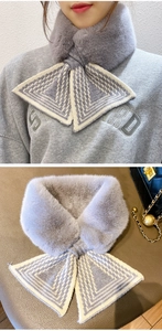 Detail of grey faux fur collar scarf with knit texture and chic cross bow-knot design
