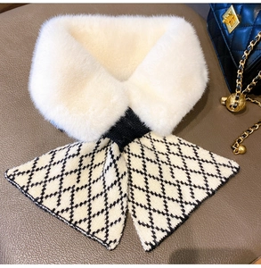Detail of plush faux fur and black and white argyle knit pattern on winter neck scarf