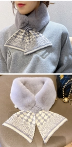 Detail of grey knitted criss-cross scarf with faux fur trim and houndstooth pattern