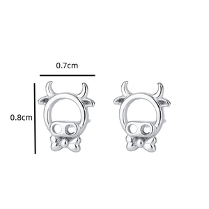 Detail view of cute hollow cow stud earrings with bow tie design, size 0.7cm by 0.8cm