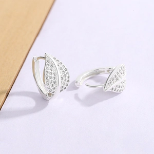 Detailed close-up of leaf-shaped hoop earrings with sparkling micro-paved zircons