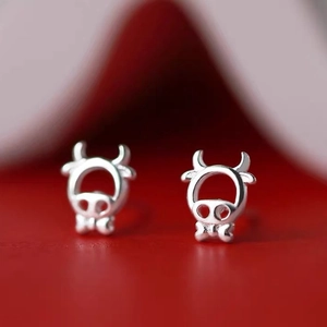 Minimalist hollow ox head earrings in S925 sterling silver with a festive red background