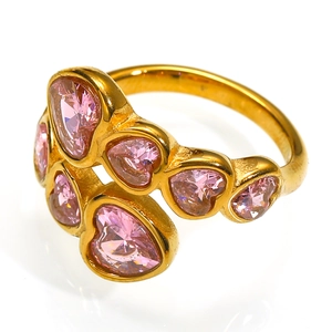 Close-up of golden crossover ring featuring six pink heart-shaped zircon gemstones