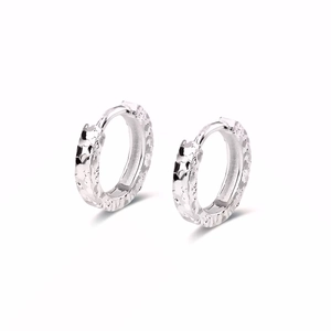 Close-up of shiny crushed ice textured silver hoop earrings with sparkling hammered finish