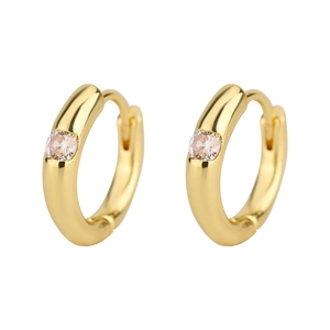 Detail of polished gold hoop earrings featuring a sparkling circular cubic zirconia stone