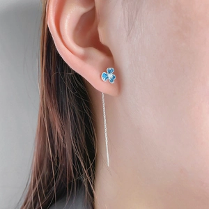 Blue enamel iris flower drop threader earrings with zircon center on model