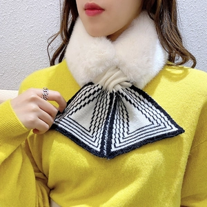 White faux fur neck warmer with black and white striped knitted bow detail for winter