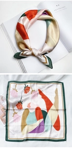 Détail d'un foulard carré en soie avec imprimés roses et bordure vert foncé élégante