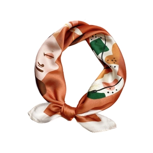 Carré de soie élégant avec motif visage abstrait en tons orange et crème, noué avec style