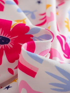 Close-up of stretchy knit fabric with bright floral digital print for girl outfit