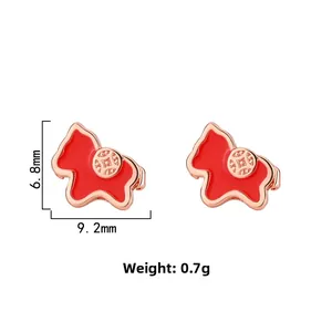 Detail view of red pig stud earrings with traditional coin motif, size 9.2mm by 6.8mm