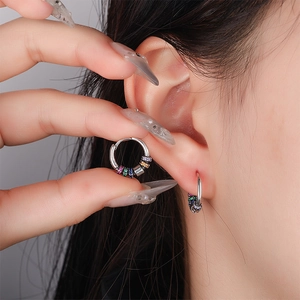Silver hoops with rainbow cubic zirconia charms shown on model for a bohemian style