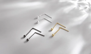 Detailed view of silver, gold and black minimalist chain threader ball drop earrings