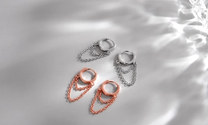Detail of S925 sterling silver hoop earrings with triple chain drop in silver and rose gold
