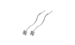 Macro shot of silver tassel earrings featuring detailed brushed cherry blossom petals