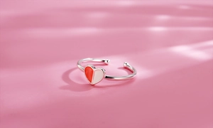 Detail of red and white enamel heart charm on an adjustable silver open ring band
