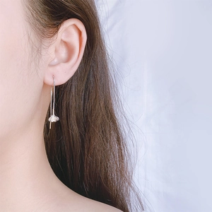 Silver ginkgo leaf tassel earrings shown on a model for a minimalist fashion look