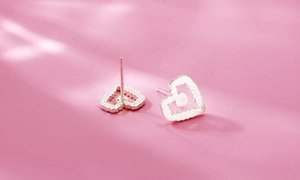 Macro view of S925 sterling silver heart earrings with a cat silhouette cutout