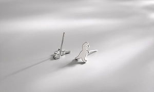 Detail view of S925 sterling silver dinosaur earrings with a polished finish and minimalist style