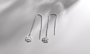 Macro detail of S925 sterling silver snowflake drop earrings with long box chain link