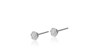 Detailed macro view of silver lotus seed pod stud earrings with textured relief details