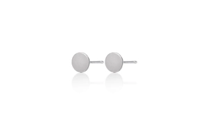 Macro detail of minimalist S925 sterling silver round stud earrings with matte brushed finish