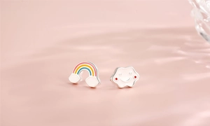 Macro shot of S925 sterling silver rainbow and smiling cloud mismatched stud earrings