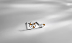 Close-up of S925 silver lemon stud earrings with orange enamel fruit slice detail