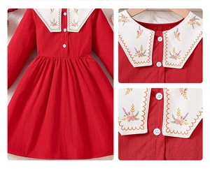 Detail of red girls' dress showing white Peter Pan collar with colorful floral embroidery