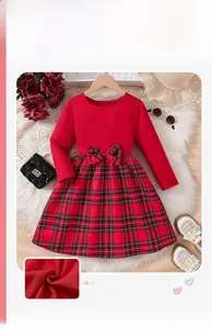 Detail of girls' Christmas plaid dress with red velvet top and waist bow decoration