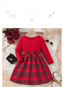 Detail of red Christmas dress for girls featuring a plaid bow and pleated skirt