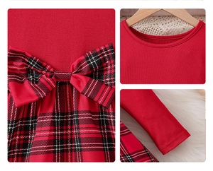 Detail of red Christmas dress featuring plaid bow decoration and knit cotton texture