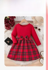 Detail of red Christmas dress for girls featuring long sleeves and a plaid bow waist