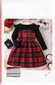 Detailed close-up of a girls red plaid dress with ruffle cuffs and black ribbed top